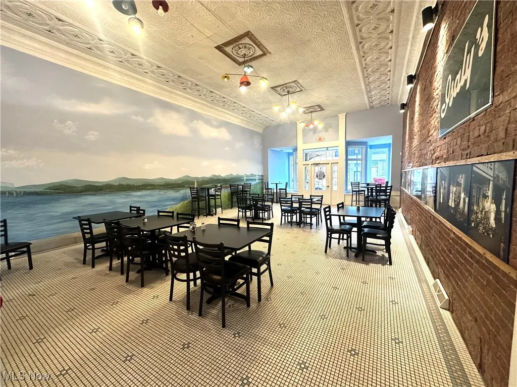 Carpeted dining room with a water view