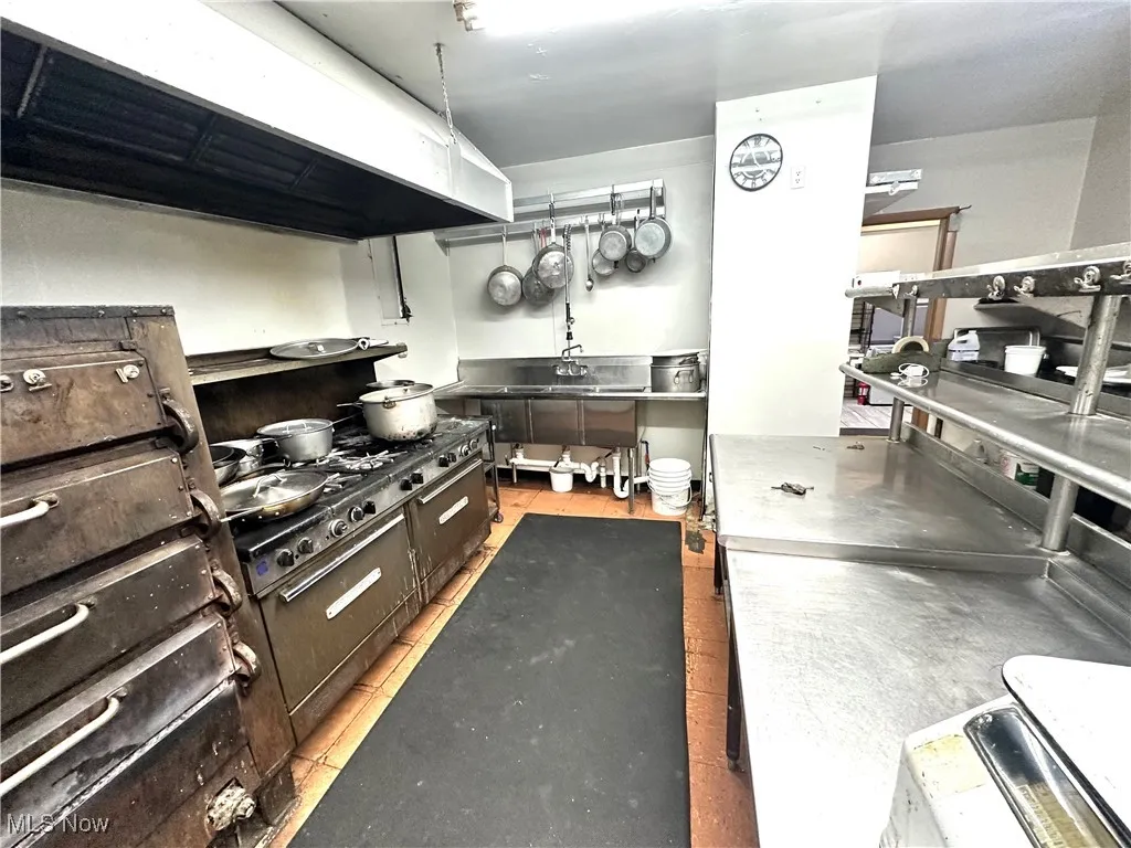 Kitchen with under cabinet range hood and stainless steel counters