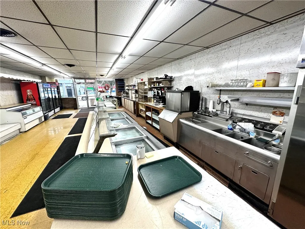 Kitchen with a paneled ceiling and open shelves