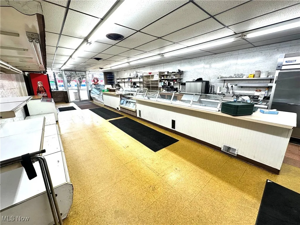 Kitchen featuring a paneled ceiling and light countertops