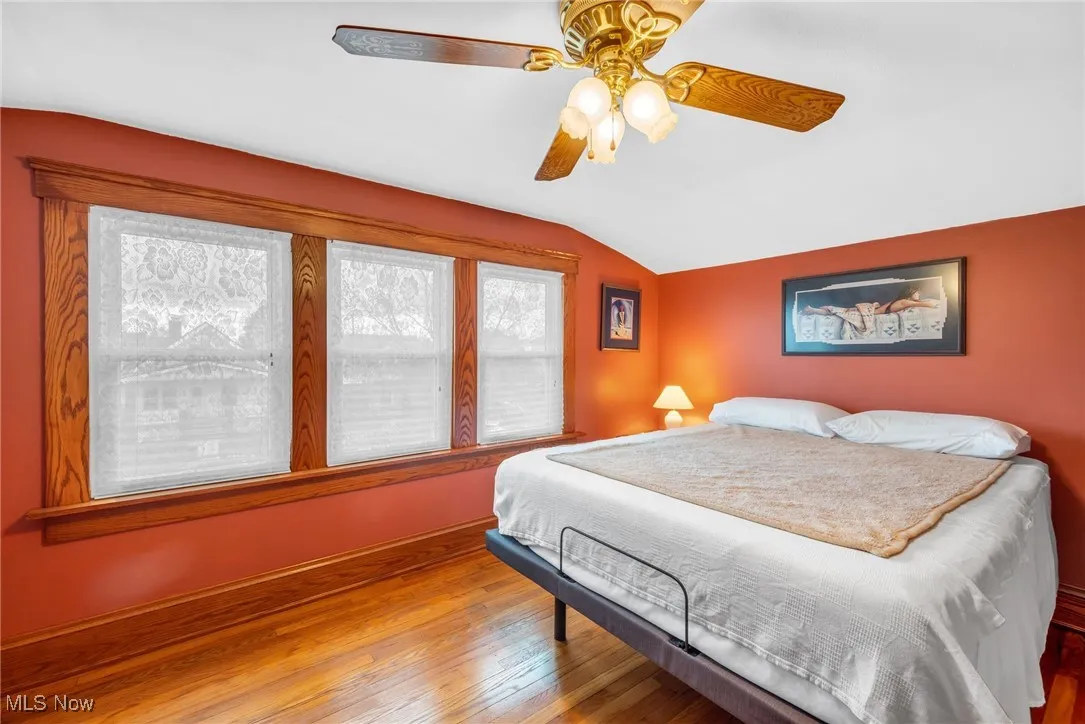 Second bedroom upstairs with ceiling fan and refinished floors.