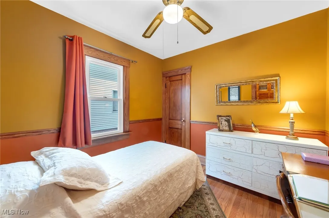 Main floor bedroom with ceiling fan and closet.