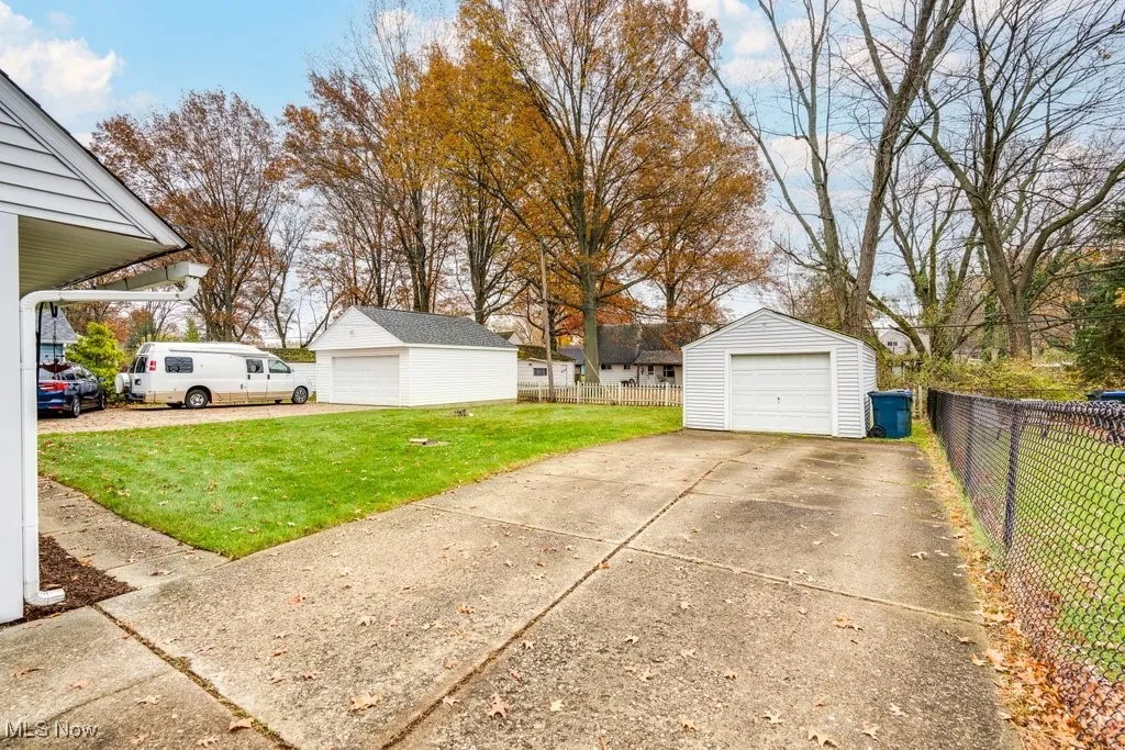 View of yard featuring a detached garage and an outdoor structure