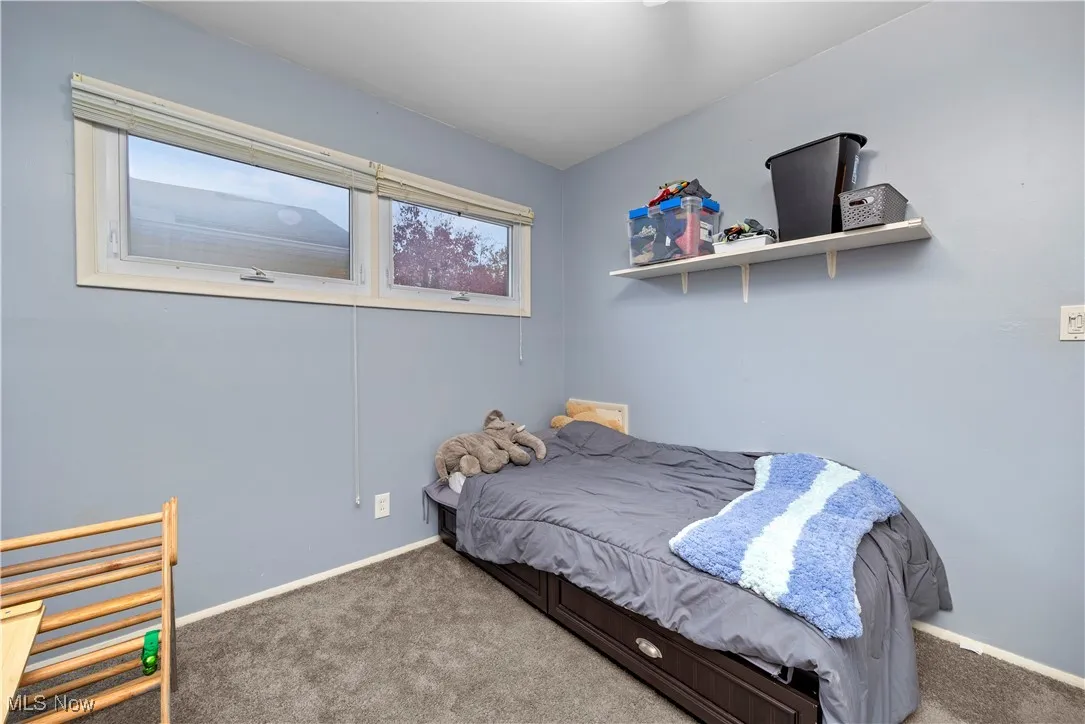 Carpeted bedroom with baseboards