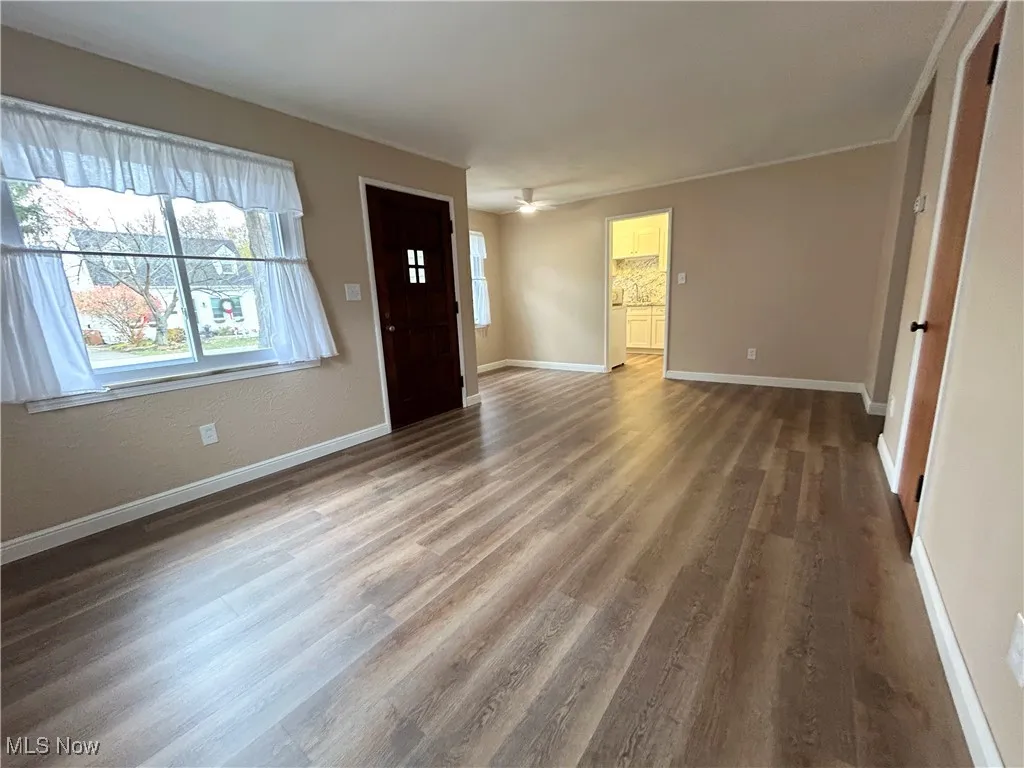 Foyer with wood finished floors and a ceiling fan