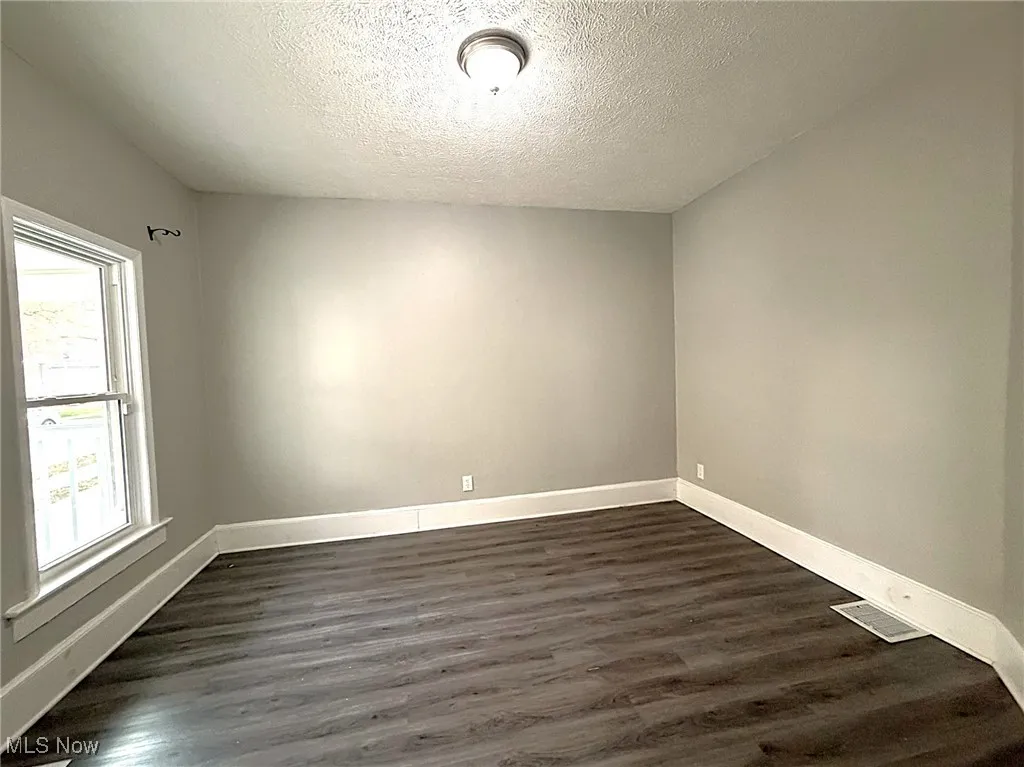 Front Sitting Room/Living Room with wood-style floors and a textured ceiling