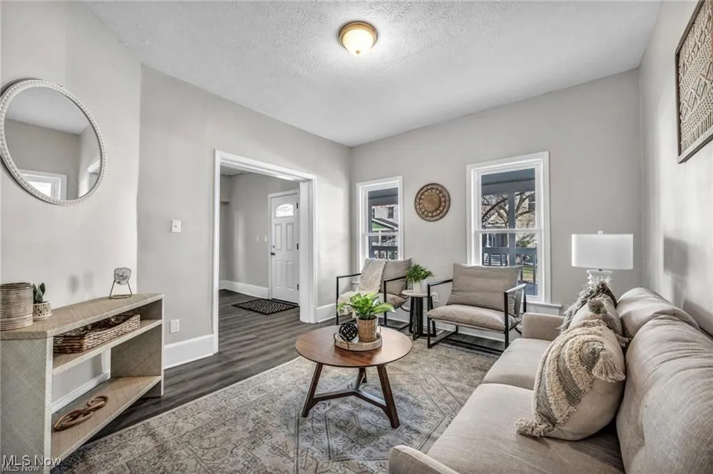 Living room featuring a textured ceiling and wood finished floors