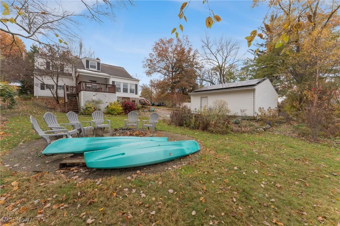 View of green lawn featuring a fire pit