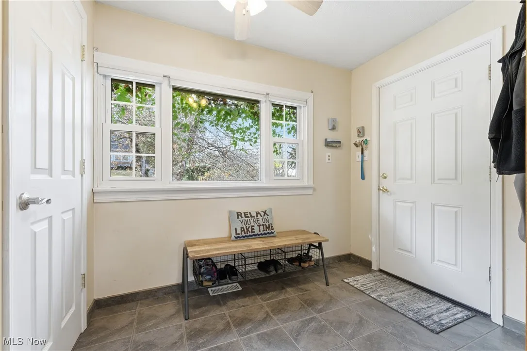 Entrance foyer featuring plenty of natural light and ceiling fan