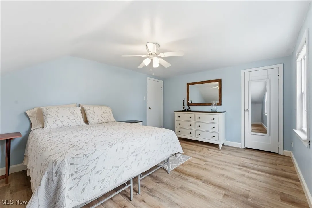 Bedroom with light wood-style floors and ceiling fan