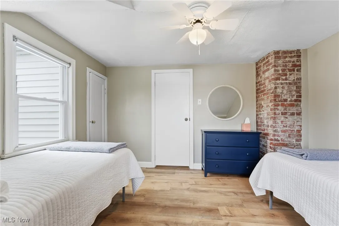 Bedroom with light wood-style floors and ceiling fan