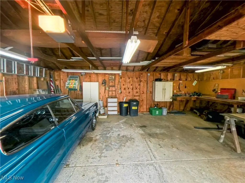 Garage with a garage door opener and a workshop area
