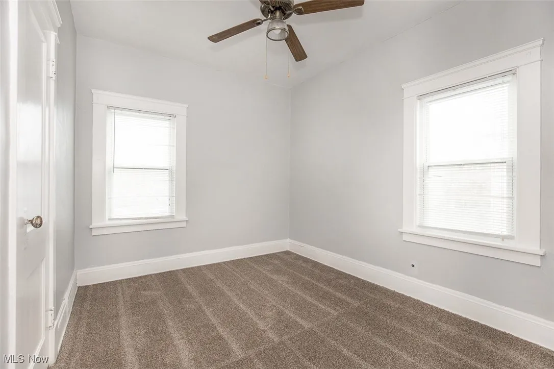 Spare room with carpet flooring and a ceiling fan