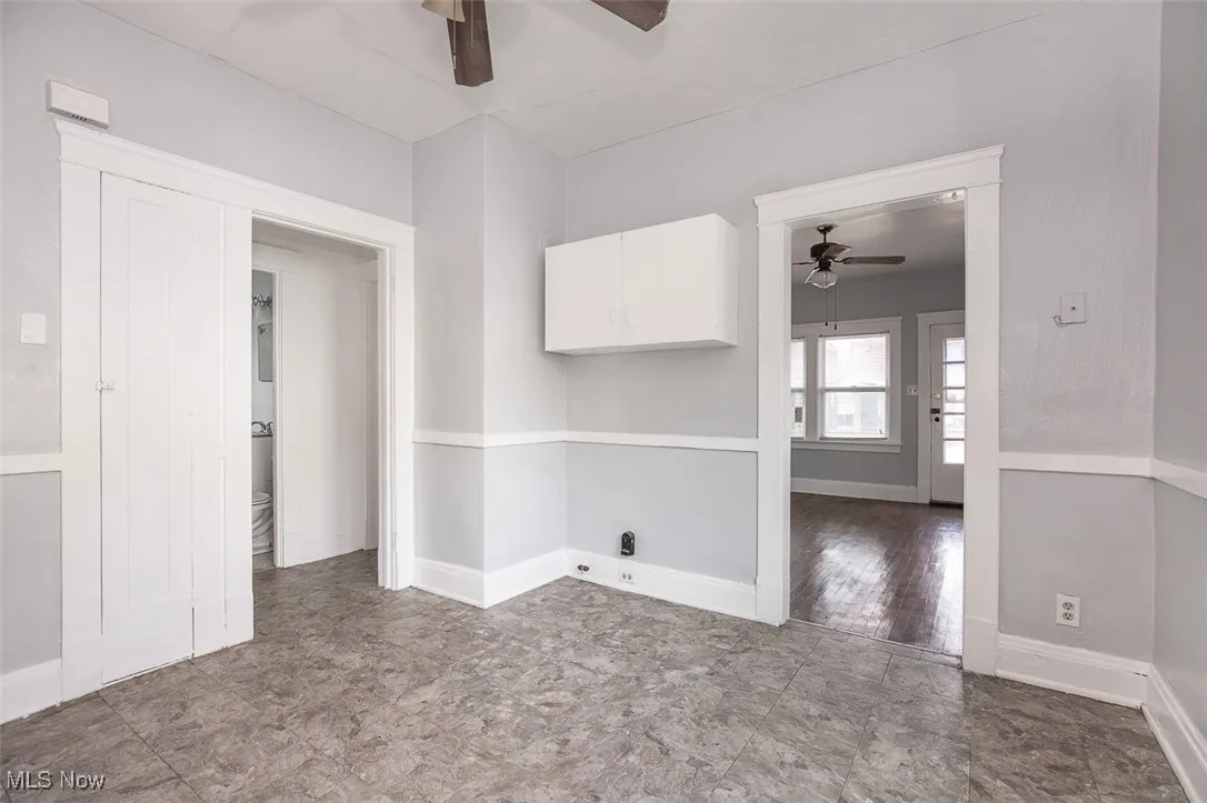 Spare room with baseboards and ceiling fan