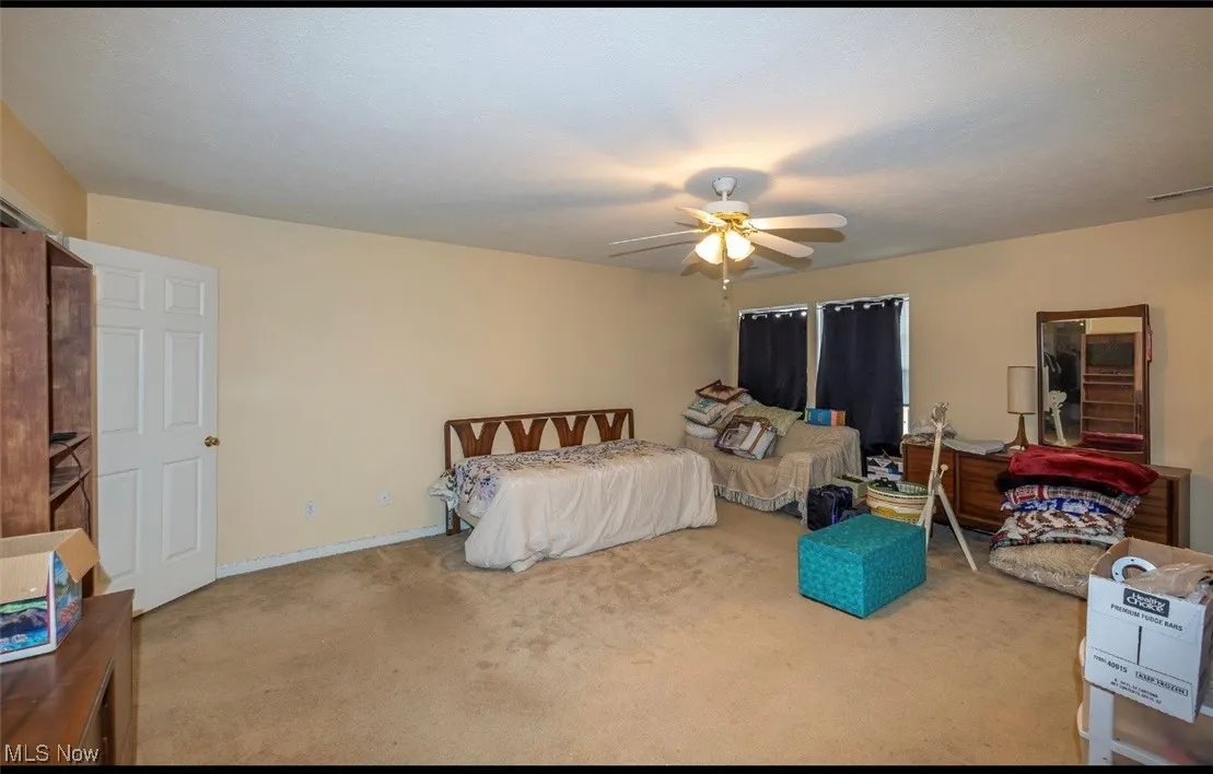 Bedroom with carpet and ceiling fan