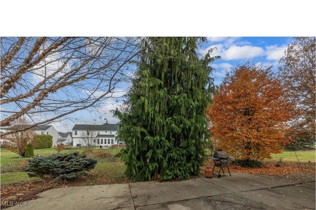 View of front facade featuring a front lawn and a patio area