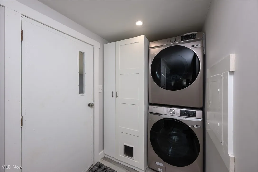 Washroom with stacked washer / dryer and recessed lighting