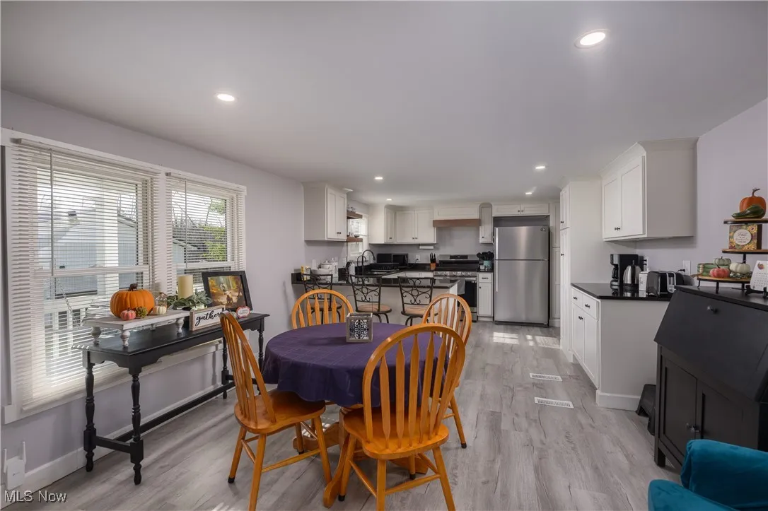 Dining room featuring light wood finished floors and recessed lighting