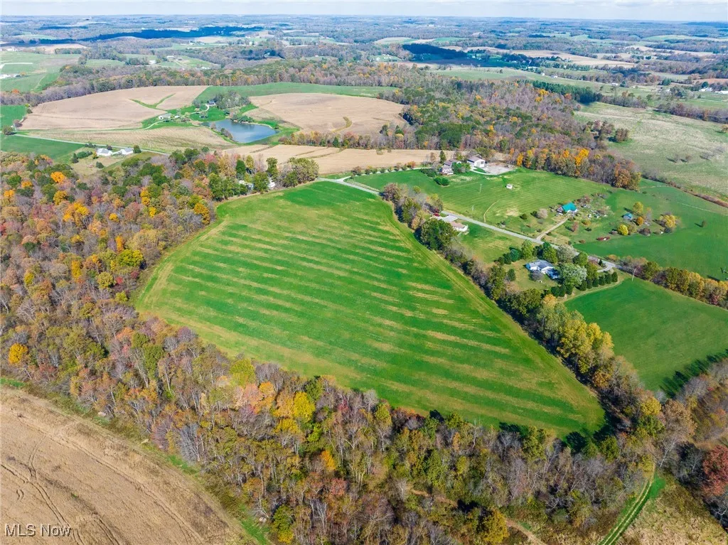 Aerial view of property and surrounding area featuring rural landscape