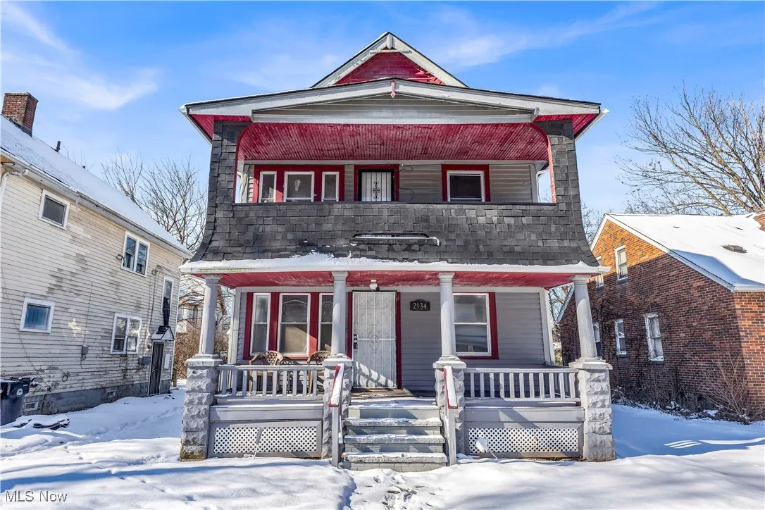 View of front of home featuring a porch and roof with shingles