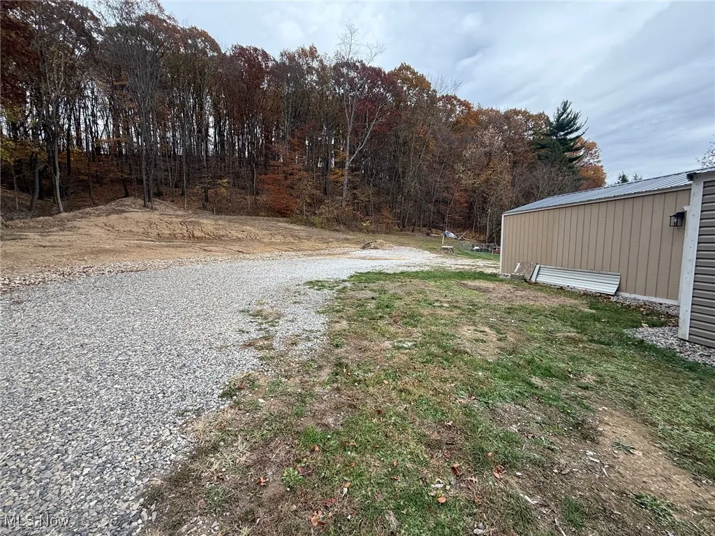 View of vacant lot and outbuilding