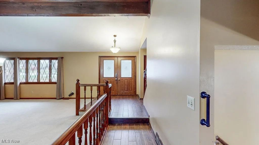 Corridor featuring hardwood / wood-style floors and baseboards