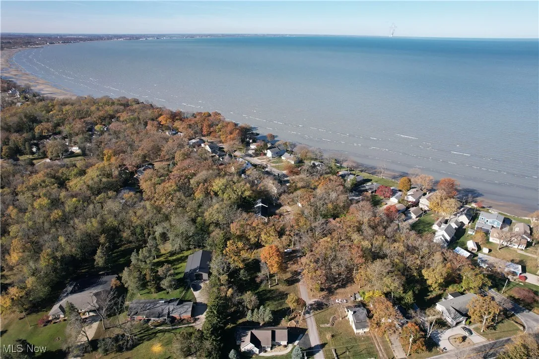 View of property location with a nearby body of water and nearby suburban area