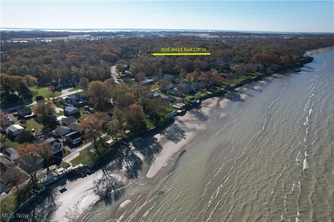 View of property location featuring a large body of water and nearby suburban area