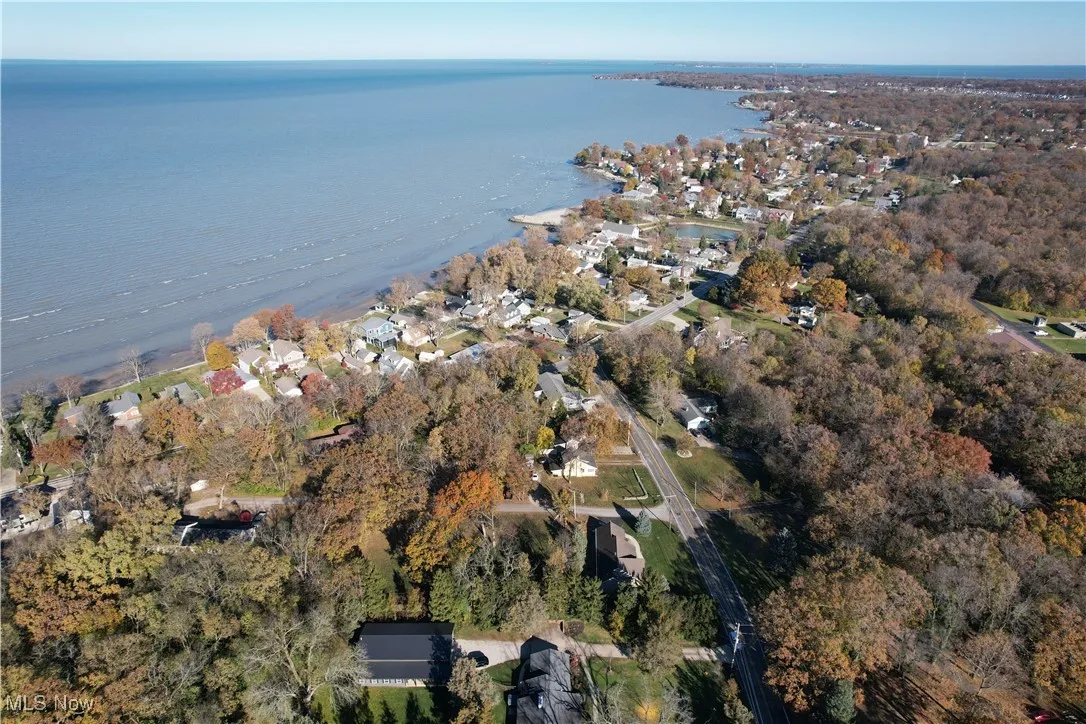 Aerial view of property's location with a nearby body of water and nearby suburban area