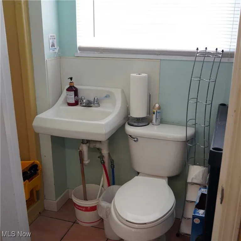 Bathroom with tile patterned flooring and toilet