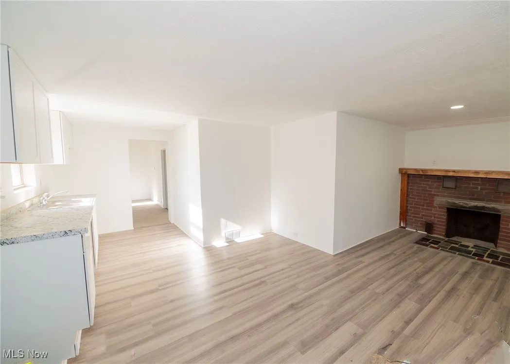 View of kitchen area with wood burning fireplace