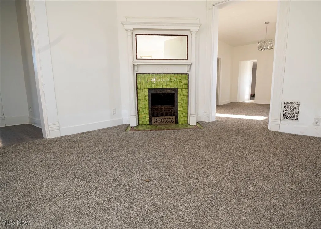View of living room area with wood burning fireplace