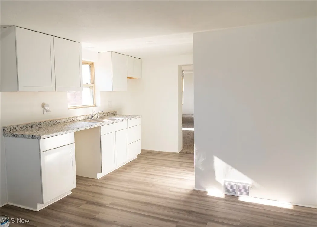 View of kitchen area with cupboard space