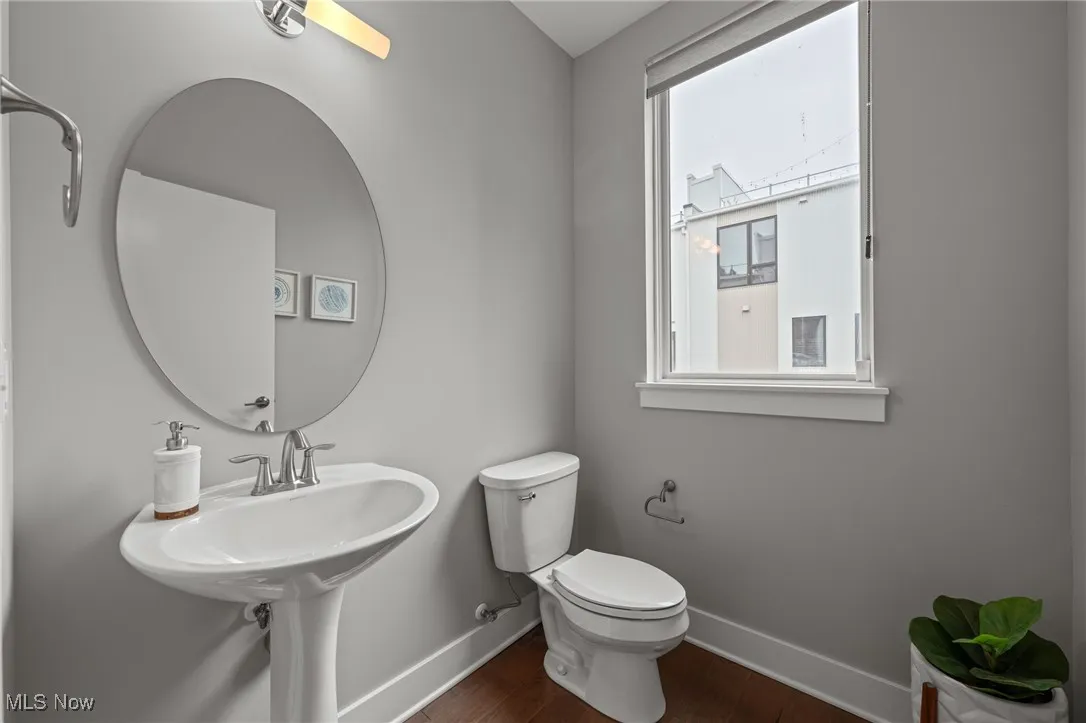 Bathroom featuring dark wood-style flooring and baseboards