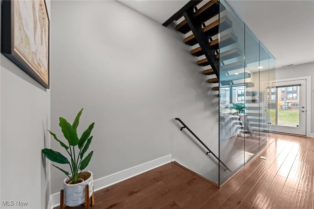 Stairs with baseboards and wood finished floors