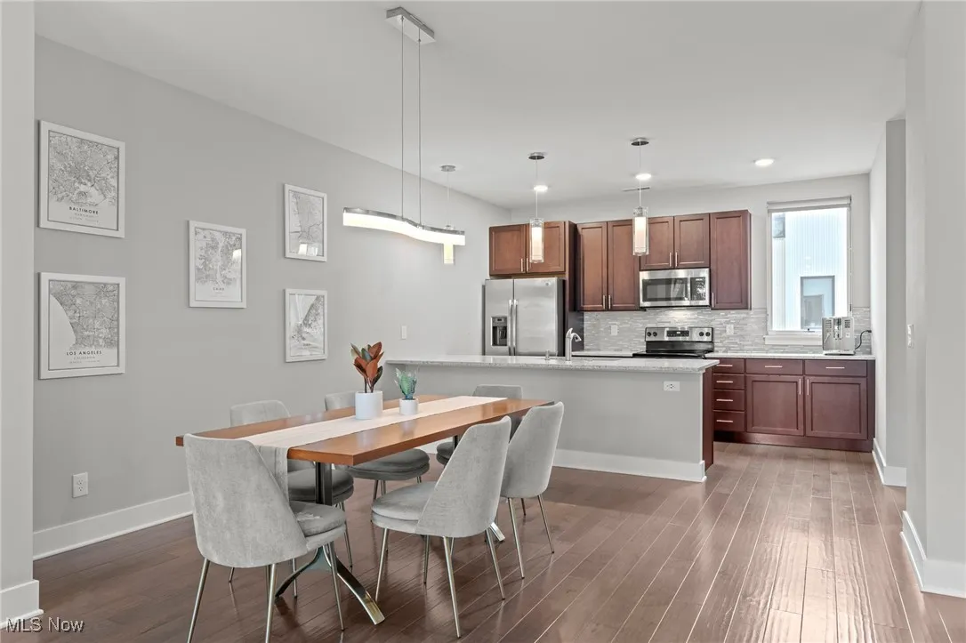 Dining area featuring dark wood-type flooring and recessed lighting