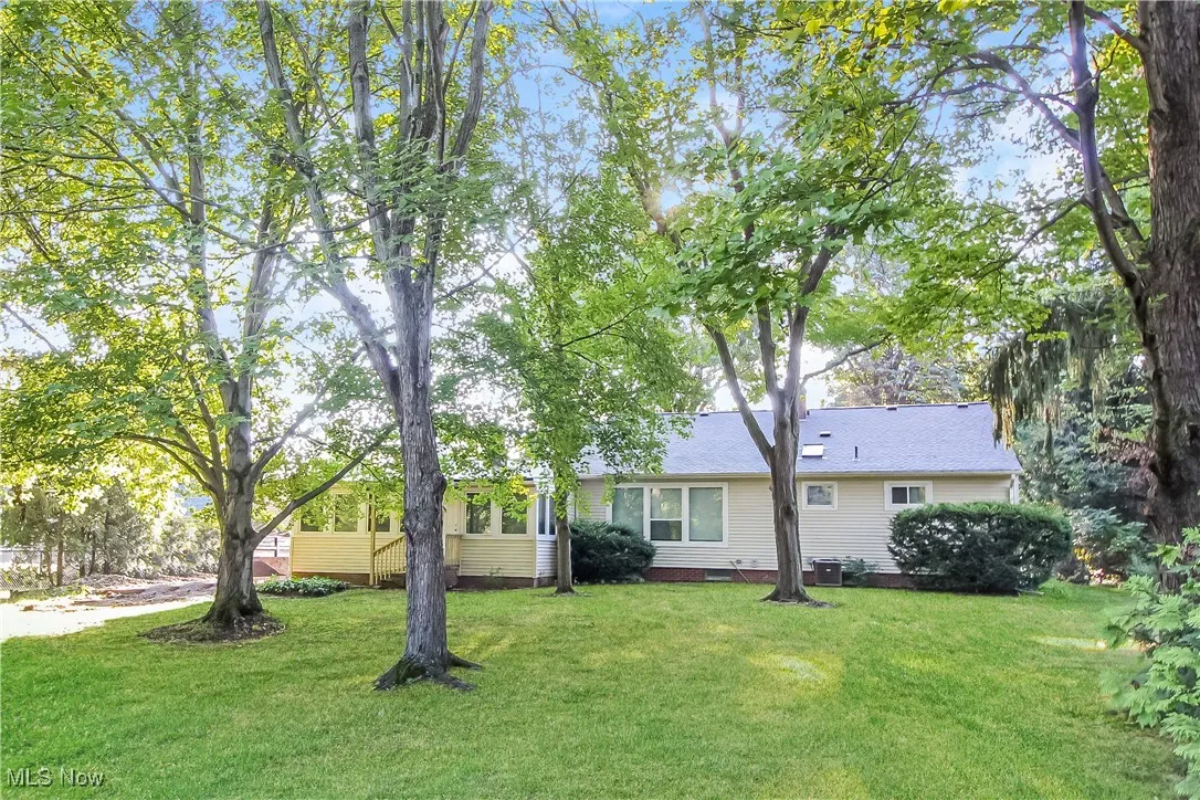 Back of property featuring a lawn and crawl space