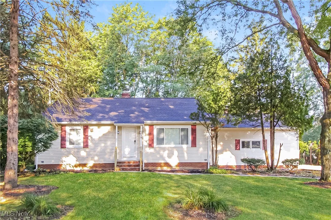 Single story home with a front lawn, roof with shingles, a chimney, and entry steps