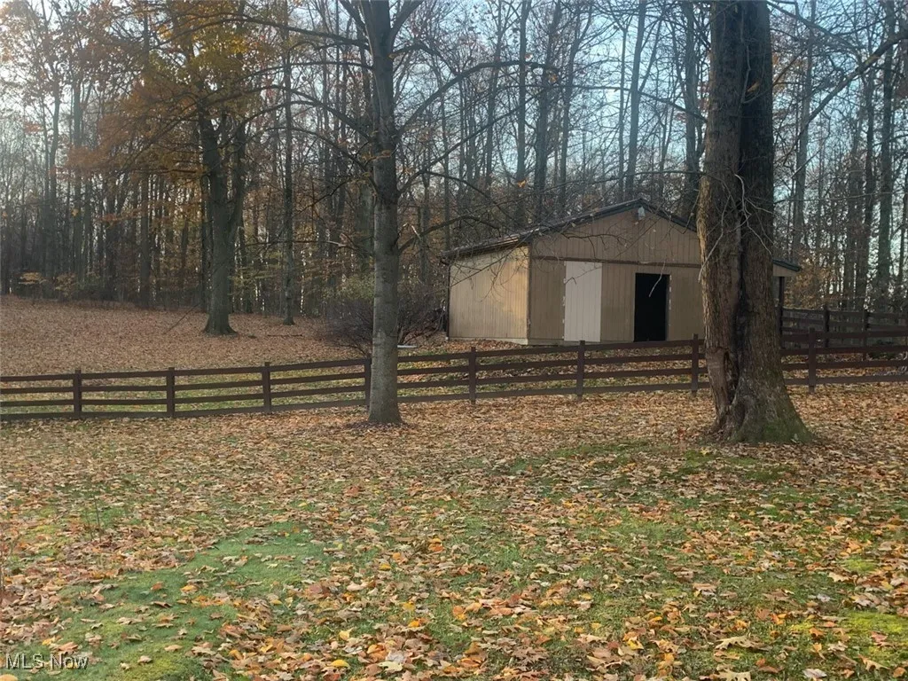 View of yard with an outdoor structure and an outbuilding
