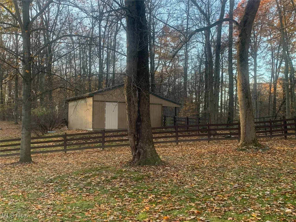 View of yard featuring an outbuilding and a pole building