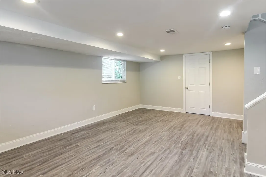 Below grade area featuring wood finished floors and recessed lighting