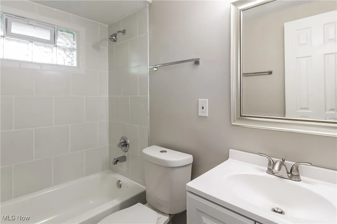 Bathroom with shower / tub combination and vanity