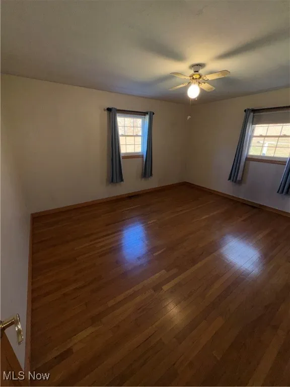 Unfurnished room featuring hardwood / wood-style floors and ceiling fan