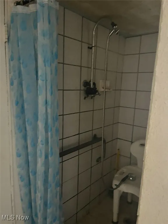 Full bath with a tile shower
