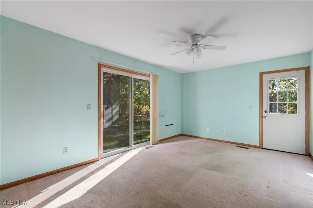 Empty room with carpet and ceiling fan