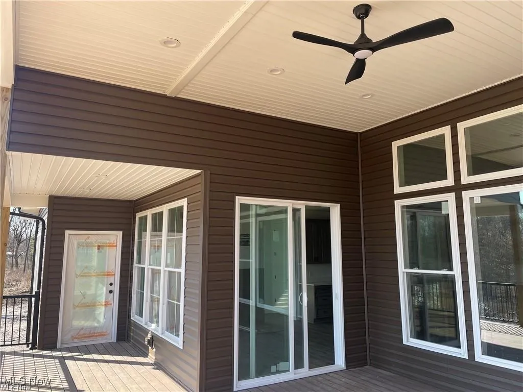 Wooden deck featuring ceiling fan