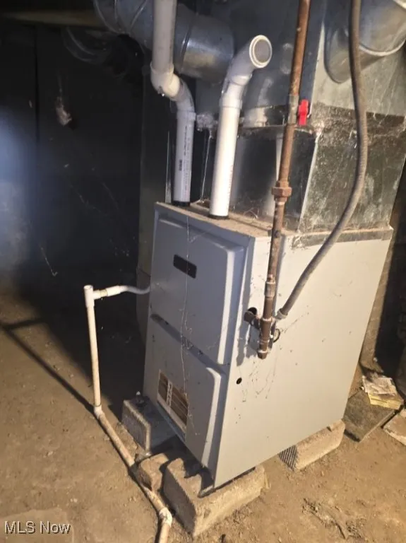 Utility room featuring heating unit