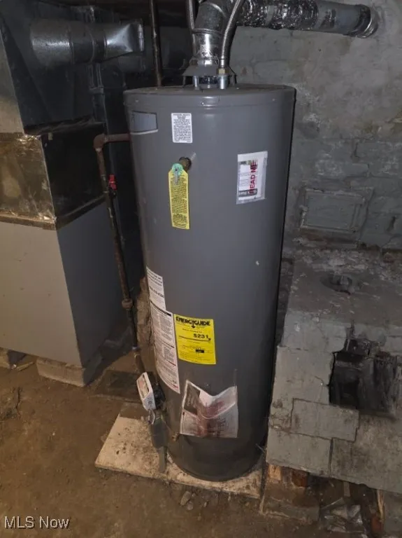 Utility room featuring gas water heater and heating unit