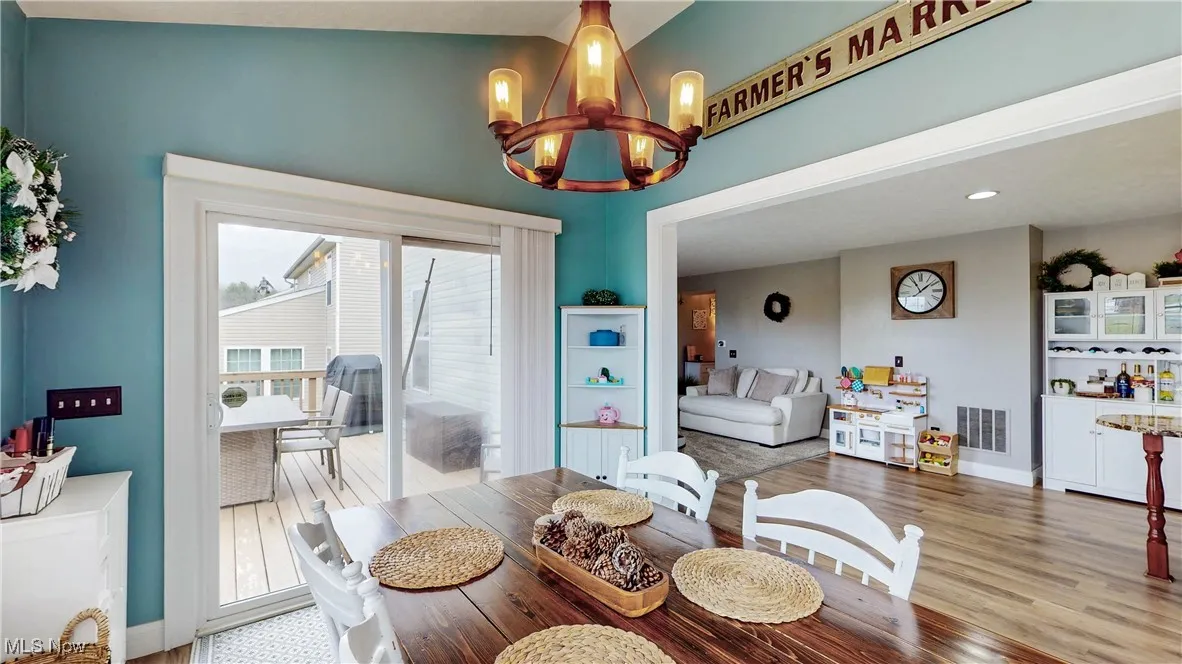 Dining space with light wood-style flooring and a chandelier