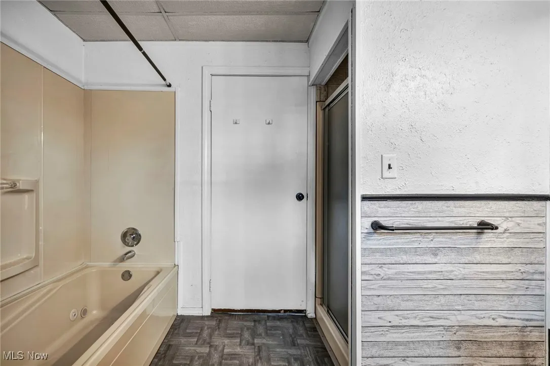 Bathroom featuring shower / bath combination with glass door